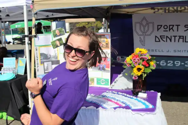 Team member in front of Port Susan Dental Care both at National Night Out