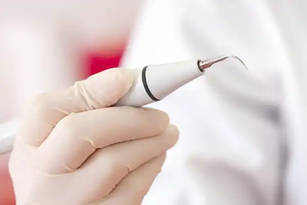 Close up of dentist holding ultrasonic scaler