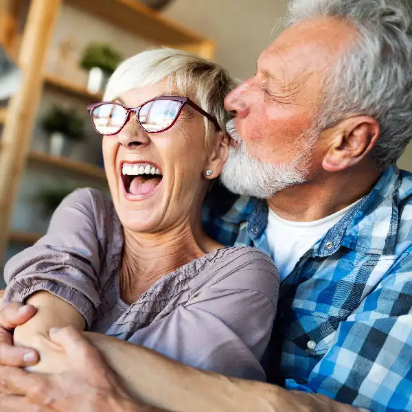A happy couple hugging and smiling at Port Susan Dental Care 