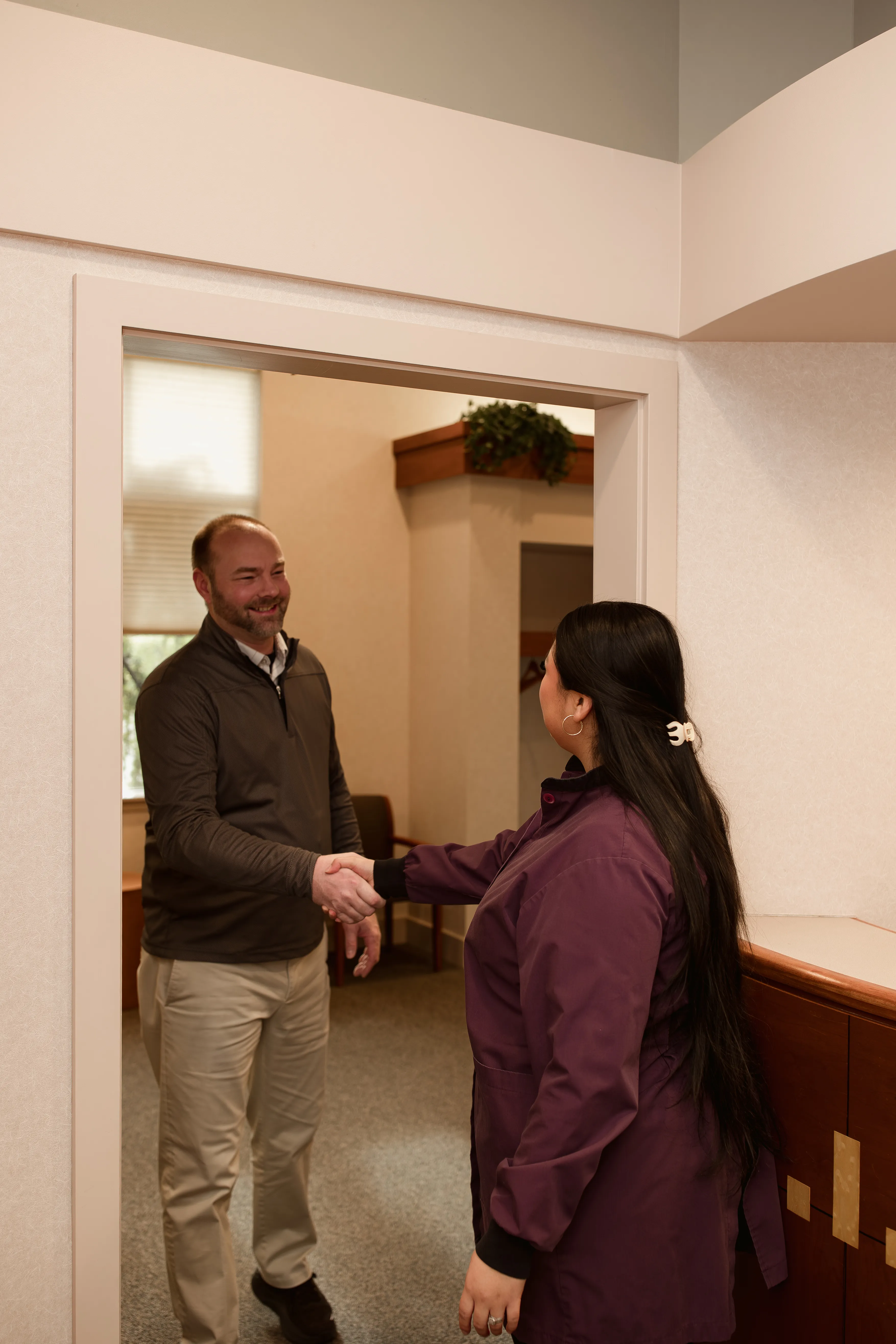 Close up of patient hands filling out patient forms on a tablet device